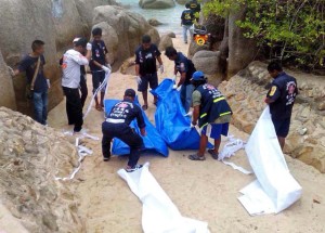 Thai workers carry the bodies of two British tourists on Koh Tao island in the Surat Thani province of southern Thailand on September 15, 2014. The naked bodies of two British tourists were found on a Thai beach, police said, sparking a murder probe on the popular resort island of Koh Tao. THAILAND OUT   AFP PHOTO        (Photo credit should read STR/AFP/Getty Images)