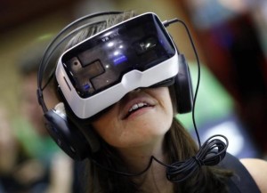 A woman tests a virtual reality headset at the Gamescom 2015 fair in Cologne, Germany