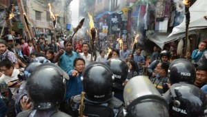 Nepalese police clash with supporters of opposition politcal parties during a protest against the draft constitution .