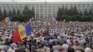 Protesters carry  Moldova's national flags during an anti-government rally, organised by the civic platform "Dignity and Truth" (DA), in central Chisinau, Moldova, September 6, 2015