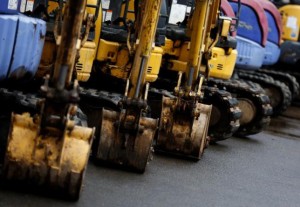Excavators are parked in a machine yard in Tokyo.