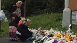 PC Phillips' wife Jen and the couple's young daughters laid flowers at the scene of his death
