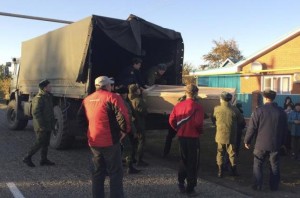 Russian servicemen unload a coffin containing the body of Vadim Kostenko, one of the Russian air force's support staff in Syria, from a truck near his family's house in the village of Grechnaya Balka, north-west of Krasnodar, Russia, October 27, 2015. 