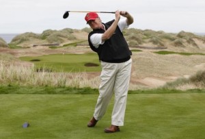 U.S. property magnate Donald Trump practices his swing at the 13th tee of his new Trump International Golf Links course on the Menie Estate near Aberdeen, north east Scotland June 20, 2011.  