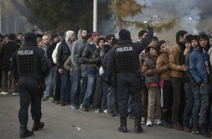 migrants wait for food and water distribution as they wait to be allowed to cross to Austria, in Sentilj, Slovenia. With the European Union estimating that three million more migrants will arrive in Europe over the next year, the patience of Slovenians, traditionally known for tolerance, is wearing thin. Their government announced Tuesday, Nov. 10, 2015, that a fence will be put up to control the flow, although not completely to stop it. 