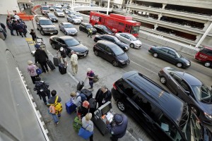 Holiday travelers appear at Los Angeles International Airport, on Tuesday, Nov. 24, 2015. An estimated 46.9 million Americans are expected to take a car, plane, bus or train at least 50 miles from home over the long holiday weekend, according to the motoring organization.