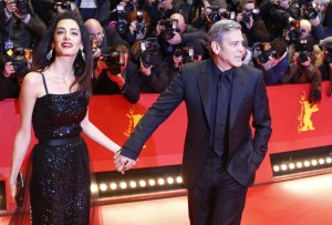 US actor George Clooney, right, and his wife Amal Clooney arrive at the red carpet for "Hail, Caesar!" the opening film of the 2016 Berlinale Film Festival in Berlin, Germany, Thursday, Feb. 11, 2016. 