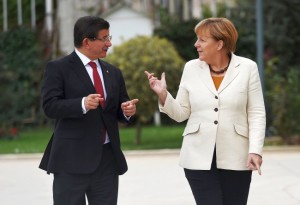 Turkish Prime Minister Davutoglu and German Chancellor Merkel chat during their meeting in Istanbul, Turkey.