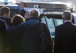 Claudio Regeni, second from right, holds his wife Paola, as they stand in front of the hearse carrying the coffin of their son Giulio at Rome's Fiumicino international airport, Saturday, Feb. 6, 2016. Giulio Regeni, 28, an Italian doctoral student disappeared in Cairo on Jan. 25, the anniversary of Egypt's 2011 uprising, a day when security forces were on high alert and on the streets in force to prevent any demonstrations or protests. His body, stabbed repeatedly and exhibiting cigarette burns and other signs of torture, was reported found on Feb. 3.