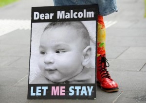 A banner calling for Australian Prime Minister Malcolm Turnbull to allow the infant children of asylum seekers to remain in Australia and not in offshore detention centers is shown during a demonstration in Melbourne, Australia, February 19, 2016. 