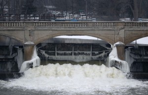 water from the Flint River flows through the Hamilton Dam near downtown Flint, Mich. 