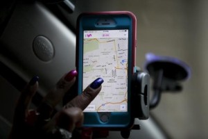 Maya Jackson, a Lyft driver from Sacramento, navigates a Lyft app on a smartphone during a photo opportunity in San Francisco, California February 3, 2016. 