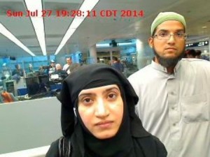 Tashfeen Malik and Syed Farook are pictured passing through Chicago's O'Hare International Airport in July 2014. 