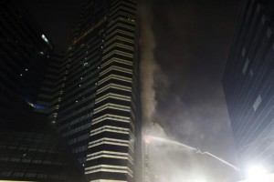 Firefighters work to extinguish a fire at the Siam Commercial Bank headquarters in Bangkok late Saturday.
