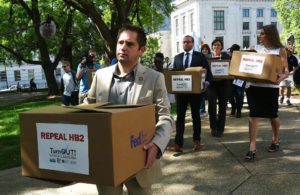 State Rep. Chris Sgro, D-Guilford, who is also executive director of Equality NC, leads a group carrying petitions calling for the repeal of House Bill 2 to Gov. Pat McCrory's office at the state Capitol building Monday, April 25, 2016, 