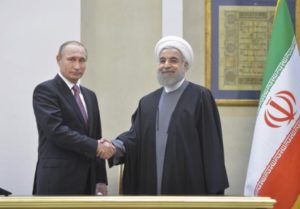 File-Russian President Vladimir Putin (L) shakes hands with his Iranian counterpart Hassan Rouhani during a news conference after the talks in Tehran, Iran, November 23, 2015. 