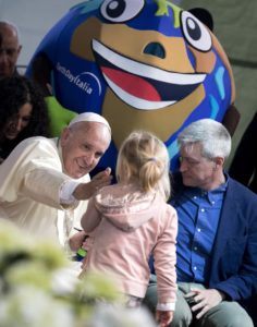 Pope Francis reaches out to caress a young girl during his appearance at an Earth Day event in Rome, Sunday, April 24, 2016.