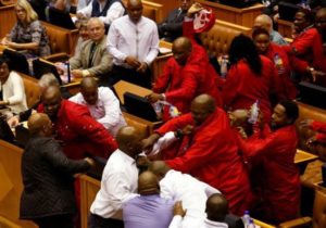 Party leader Julius Malema and members of his Economic Freedom Fighters (EFF) clash with Parliamentary security as they are evicted from the chamber in Cape Town, South Africa, May 17, 2016.