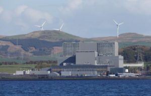 File-Wind turbines are seen behind Hunterston B Nuclear Power Station in West Kilbride, Scotland May 15, 2013. 