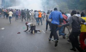 Protesters run away from the police during clashes in Nairobi, Kenya May 16, 2016. 