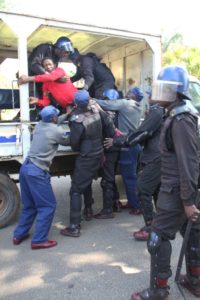 Zimbabwean activist Sten Zvorwadza,centre, is arrested following a protest at a local hotel in Harare, in this Friday, June, 24, 2016.