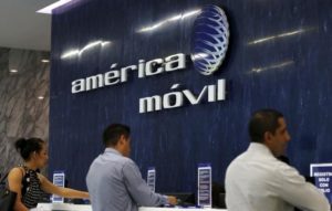 The America Movil logo is seen on the wall of the reception area in the company's corporate offices in Mexico City .