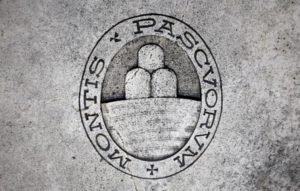 A logo of Monte dei Paschi di Siena bank is seen on the ground in downtown Siena, Italy.