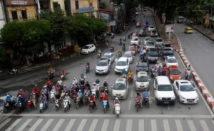 Motorcycles and cars stop on a street in Hanoi, Vietnam June 30, 2016.