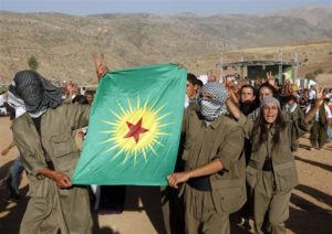 File-Turkish Kurdish youths dressed as PKK militants chant slogans in the town of Eruh, southeastern Turkey, in this August 15, 2009 