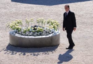 French President Francois Hollande walks past white roses, each representing one of the 86 victims, during the ceremony in tribute to the victims and the families of the fatal truck attack three months ago, in Nice, France, October 15, 2016. REUTERS/Jean-Pierre Amet