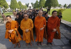 Buddhist monks and Thais line up to offer condolences for Thailand's King Bhumibol Adulyadej at Grand Palace in Bangkok, Thailand, Friday, Oct. 14, 2016. Grieving Thais went to work dressed mostly in black Friday morning, just hours after the palace announced the death of their beloved King Bhumibol, the politically fractious country's unifying figure and the world's longest-reigning monarch. He was 88. 