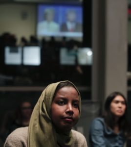 Fadumo Osman, left, political director for NYU College Democrats, watches the presidential debate between Democratic candidate Hillary Clinton and Republican candidate Donald Trump during a debate watch gathering, Wednesday, Oct. 19, 2016, in New York.