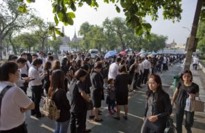 Thai people stand in lines to offer condolences for Thai King Bhumibol Adulyadej at Grand Palace in Bangkok, Thailand, Friday, Oct. 14, 2016. Grieving Thais went to work dressed mostly in black Friday morning, just hours after the palace announced the death of their beloved King Bhumibol, the politically fractious country's unifying figure and the world's longest-reigning monarch.