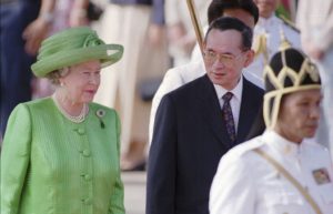 Oct. 28, 1996, file photo, Thailand's King Bhumibol Adulyadej, second right, walks with Britain's Queen Elizabeth II after her arrival at Bangkok's military airport. Thailand's Royal Palace said on Thursday, Oct. 13, 2016, that Thailand's King Bhumibol Adulyadej, the world's longest-reigning monarch, has died at age 88.