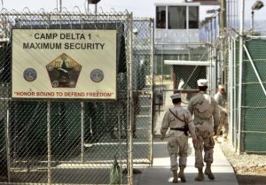 U.S. Department of Defense official, U.S. military guards walk within Camp Delta military-run prison, at the Guantanamo Bay U.S. Naval Base, Cuba.