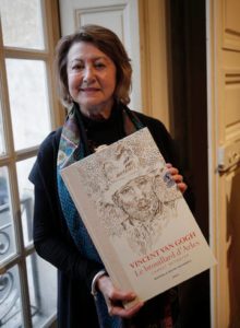 Art historian Bogomila Welsh-Ovcharov poses with the book Vincent Van Gogh: "The Lost Arles Sketchbook,"