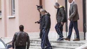 The two Italian hostages that were freed in Libya, Bruno Cacace, second from left, and Danilo Calonego, second from right, leave a police station after being questioned by prosecutor Sergio Colaiocco, in Rome, Saturday, Nov. 5, 2016. The two had been kidnapped at Gath, Libya, on Sept. 19. 