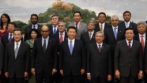Chinese President Xi Jinping (C) takes photos with guests of the Asian Infrastructure Investment Bank at the Great Hall of the People in Beijing on October 24, 2014. - 