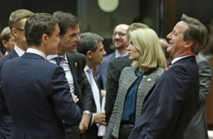 From left, Finnish Prime Minister Alexander Stubb, Estonian Prime Minister Taavi Roivas, Dutch Prime Minister Mark Rutte, Danish Prime Minister Helle Thorning-Schmidt and British Prime Minister David Cameron speak during a round table meeting at an EU summit in Brussels, on Thursday, Oct. 23, 2014. EU leaders will gather Thursday for a two-day summit in which they will discuss Ebola, climate change and the economy.