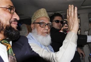 FILE - In this Wednesday, Jan. 11, 2012 file photo, former chief of Bangladesh's largest Islamic party Jamaat-e-Islami, Ghulam Azam, waves from inside a car on his way to a court in Dhaka, Bangladesh. Azam, 91, died late Thursday, Oct. 23, 2014 after life support was removed at the Bangabandhu Sehikh Mujib Medical University in the capital, Dhaka, said hospital spokesman Abdul Majid Bhuiyan. (AP Photo/Shawkat Khan)