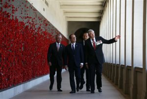 CORRECTS POSITION OF NELSON - rench President Francois Hollande, second left, walks along the Roll of Honour Wall with Australian Prime Minister Tony Abbott, second right, Australian War Memorial Director Brendan Nelson, left, and Chairman of the War Memorial Rear Admiral Ken Doolan at the Australian War Memorial in Canberra Wednesday, Nov. 19, 2014. Hollande is on a three-day official visit to Australia following the G-20 leaders summit in Brisbane over the weekend. (AP Photo/