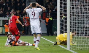 Bayern's Mario Goetze, bottom left, is comforted by Leverkusen's Omer Toprak from Turkey after he failed to score during the German soccer cup (DFB Pokal) quarterfinal match between Bayer 04 Leverkusen and Bayern Munich Wednesday, April 8, 2015 in Leverkusen, Germany