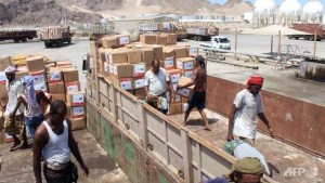 Yemeni workers unload medical aid boxes from a boat carrying 460 tonnes of Emirati relief aid that docked in Yemen's restive port city of Aden.