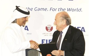 FIFA president Sepp Blatter (R) and Qatar Football Association (QFA) President Sheik Hamad Bin Khalifa Bin Ahmed al-Thani exchange documents after officially appointing Qatar as the host of the 2022 FIFA World Cup, in Doha 