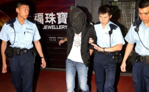 Tong Mong-leong, pictured here with his face covered when he was arrested last year, pleaded guilty.