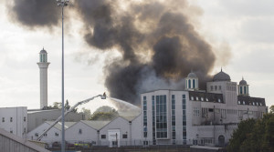 Firefighters tackle a blaze at the Baitul Futuh Mosque in Morden, south west London on September 26, 2015.
