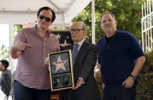 Italian composer Ennio Morricone (C) poses on his star with director Quentin Tarantino (L) and producer Harvey Weinstein after it was unveiled on the Hollywood Walk of Fame in Hollywood, California February 26, 2016. 
