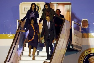 U.S. President Barack Obama and First Lady Michelle Obama arrive for their visit to Argentina with their daughters Malia (top, L) and Sasha at Buenos Aires' international airport, early March 23, 2016. 