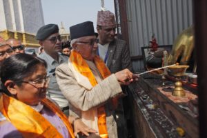 Nepalese Prime Minister Khadga Prassad Oli, center, lights a butter lamp to initiate reconstruction work in Swayambhunath stupa that was destroyed in last years's earthquake in Kathmandu, Nepal, Monday, April 25, 2016. 