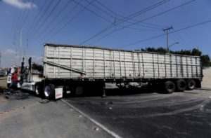 The wreckage of a tractor-trailer set ablaze by members of a drug cartel is seen blocking a road in Guadalajara May 1, 2015. 